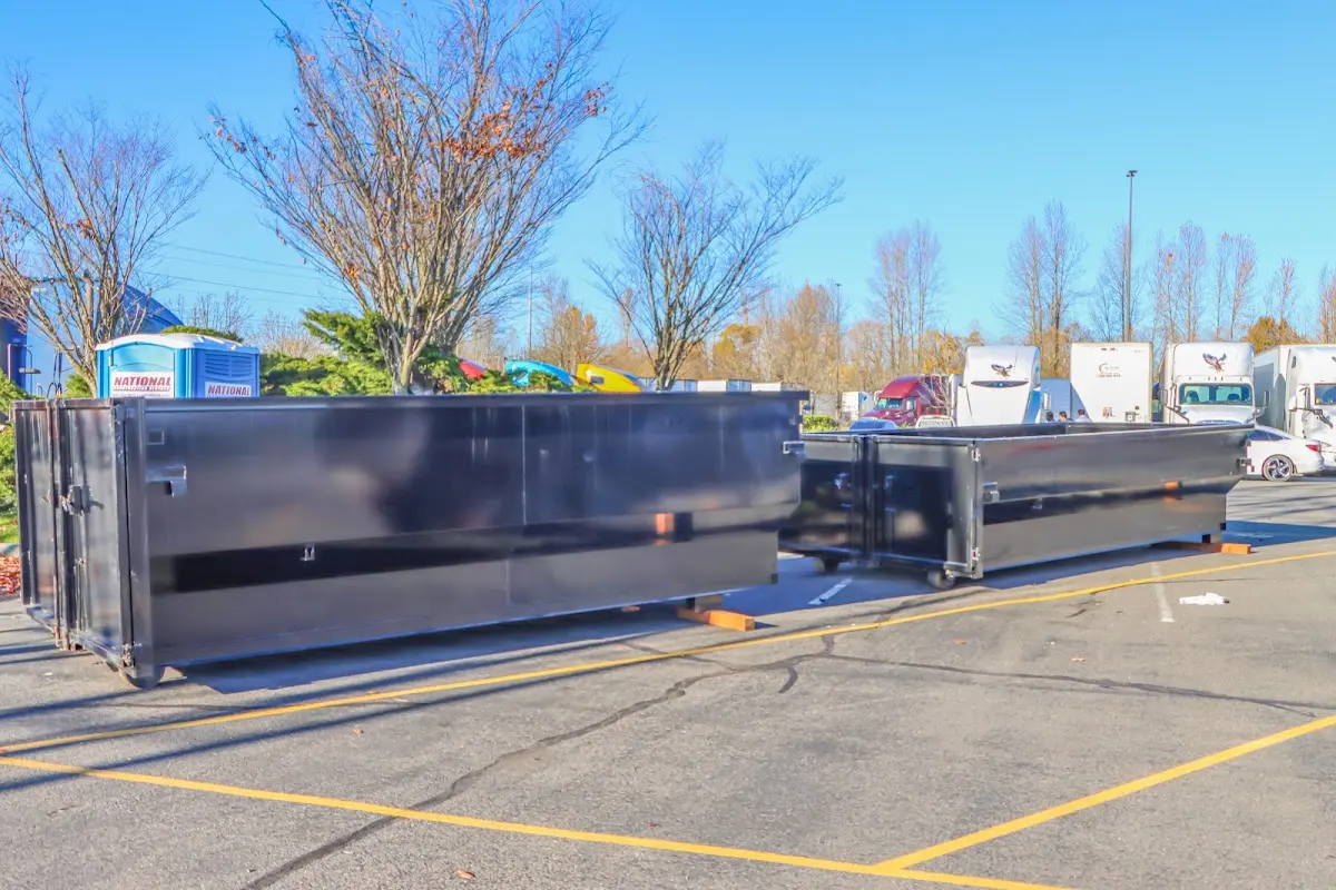 Professional dumpster rental service with roll-off container on residential driveway in Lapeer